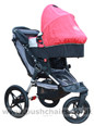Baby Jogger Summit ATP front wheel in swivel mode, with Red Carrycot - click for larger image